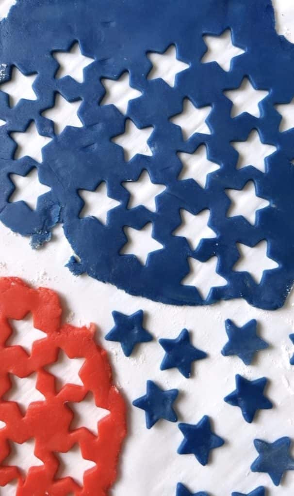 blue and red cookie dough with stars cut out of them