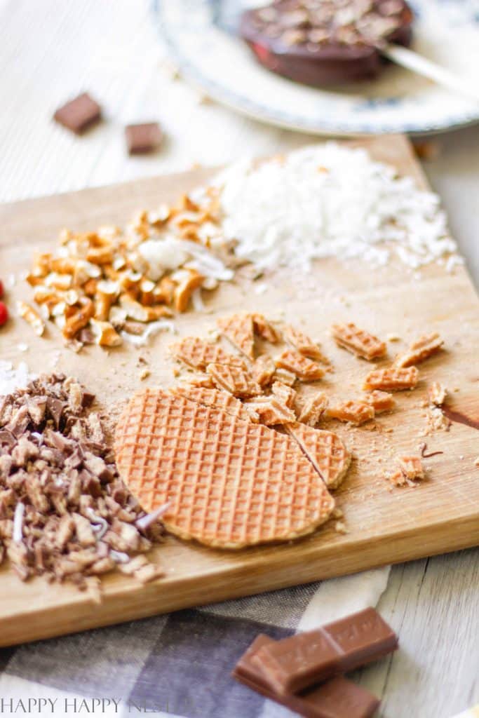 Chopped up stroopwafel cookie on a wooden cutting board