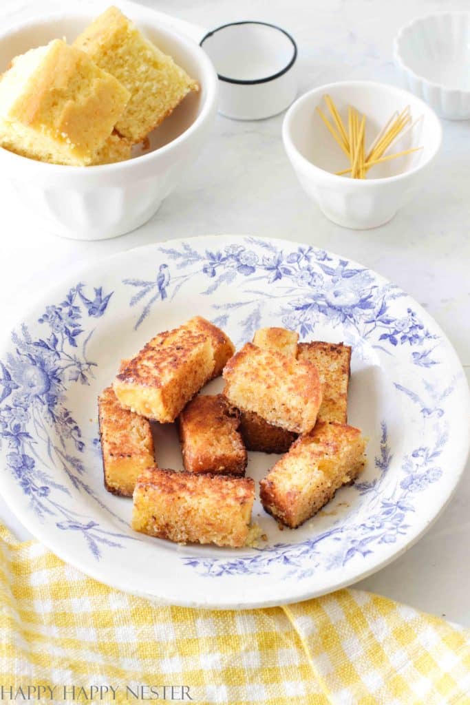 cornbread appetizers on a blue French plate on a white table