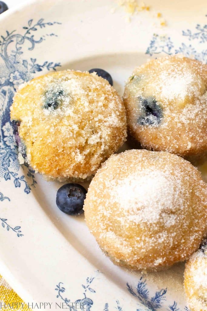 sugar covered blueberry muffins on a French blue platter