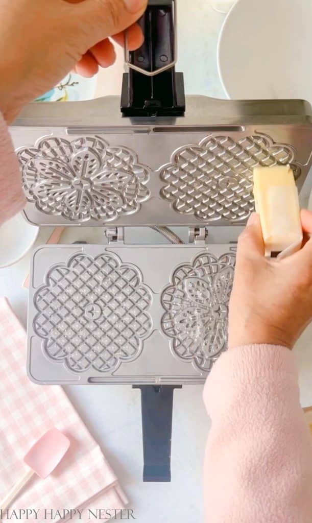 buttering the pizzelle maker for this recipe for gluten free pizzelles