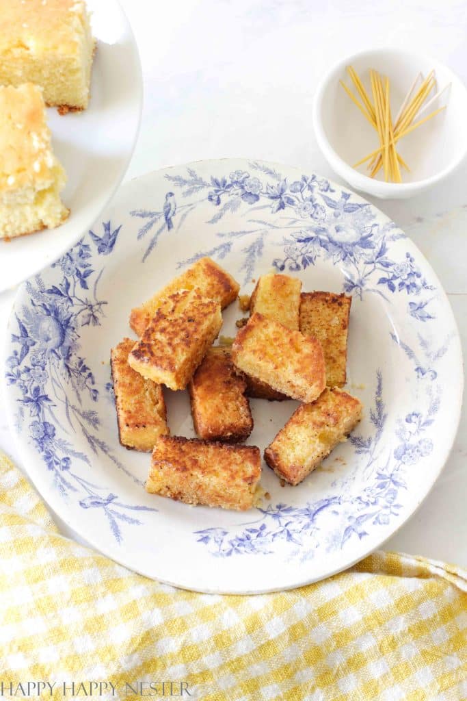 cornbread appetizers recipe in a French blue bowl surrounded by a yellow gingham kitchen towel.