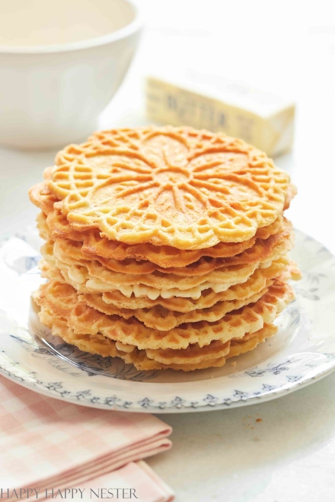 A stack of pizzelle cookie on a blue French plate