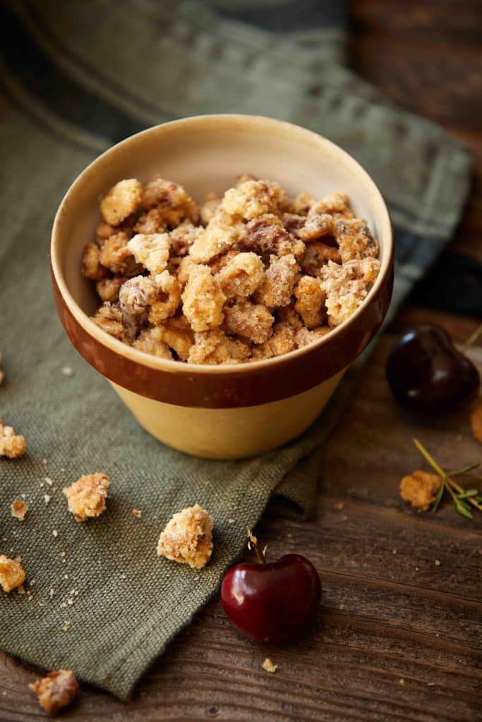 a close up a bowl of sugared walnuts used in stone grilled fruit salad