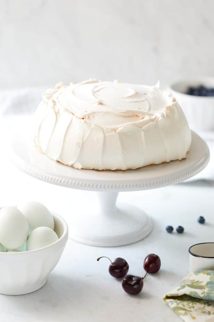 bake pavlova on a white cakestand ready to add whip cream and fresh fruits
