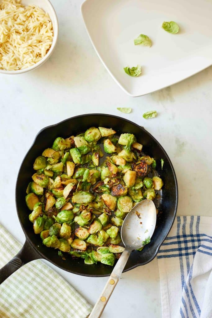frying brussel sprouts in a cast iron pan