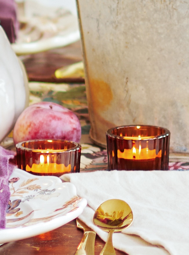 Amber glass votives with candles in them