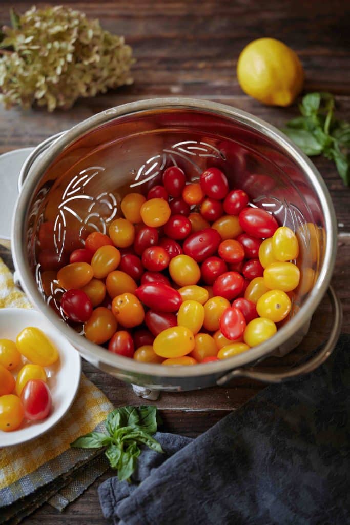 a strainer full of cherry tomatoes
