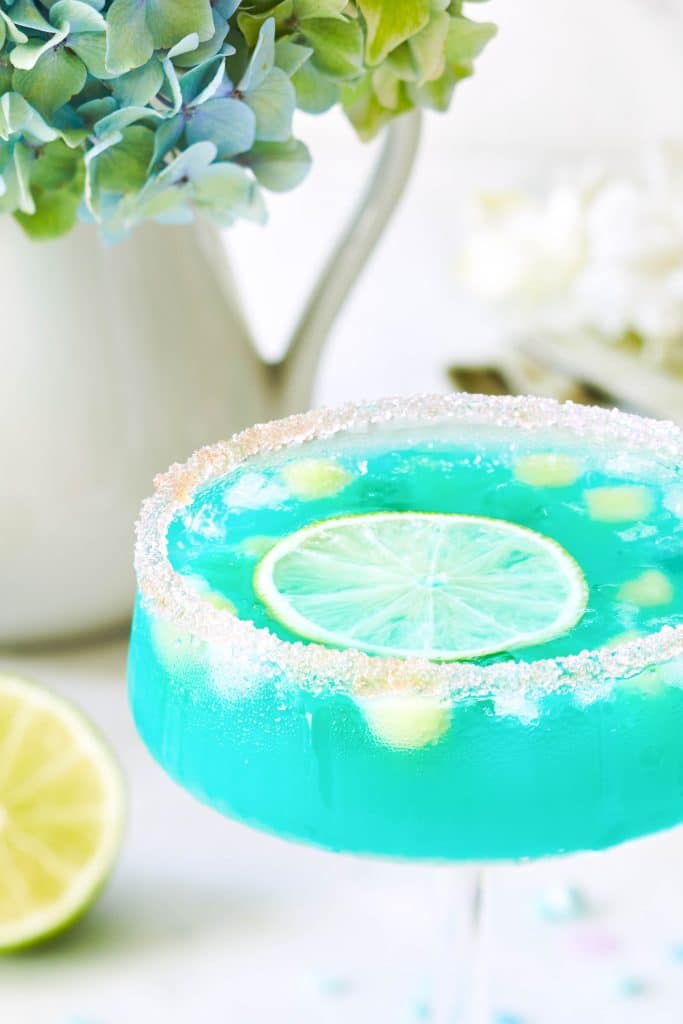 close up of the mermaid water drink with a lime floating on top
