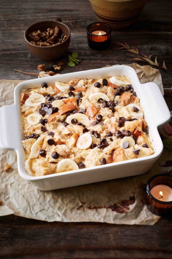 A pan of uncooked chocolate banana bread pudding in a white ceramic pan
