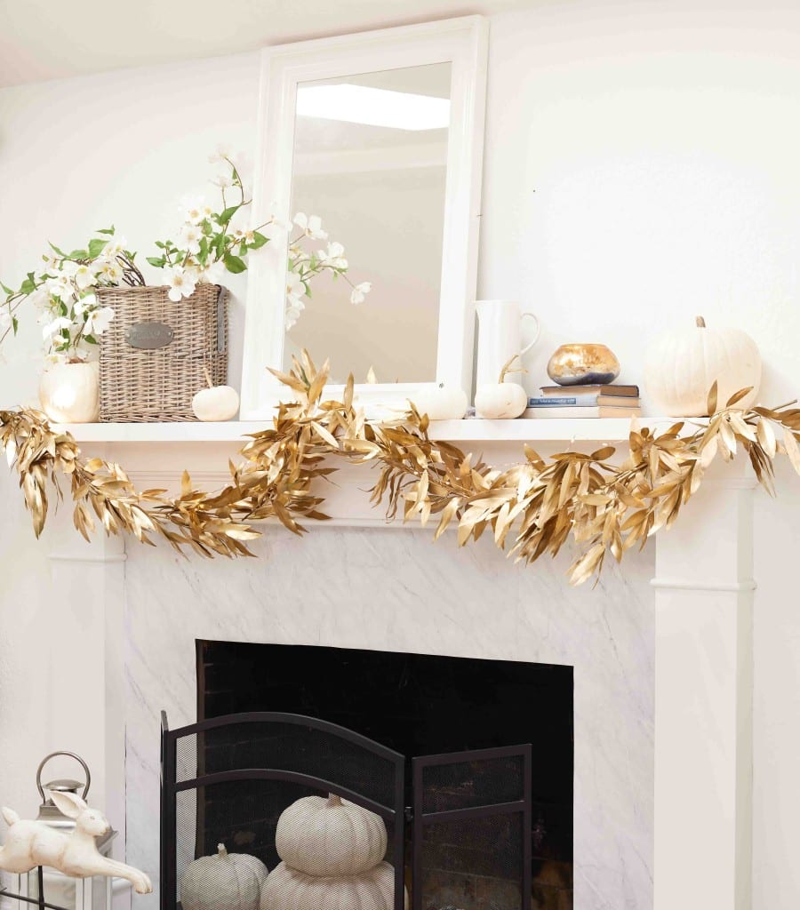 gold fall garland hanging from a white mantel