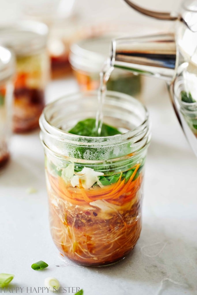 pouring hot water in a mason jar instant noodles