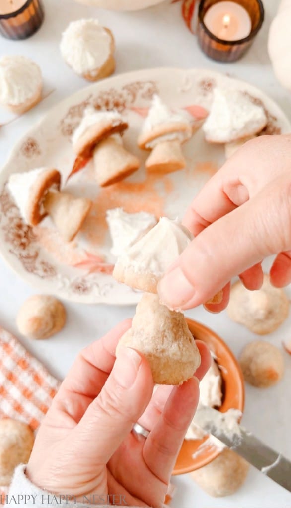 showing how to place the cap of the mushroom on the cookie stem