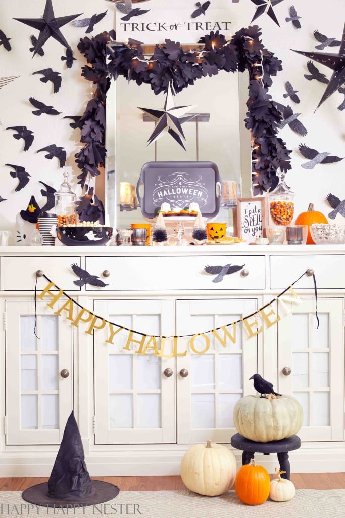 a totally decorated Halloween buffet table with lots of desserts