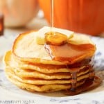 closeup of a stack of buttermilk pumpkin pancakes with syrup being poured on top