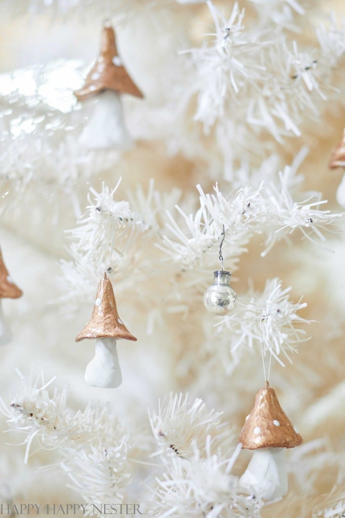 clay mushrooms hanging from a Christmas tree branch