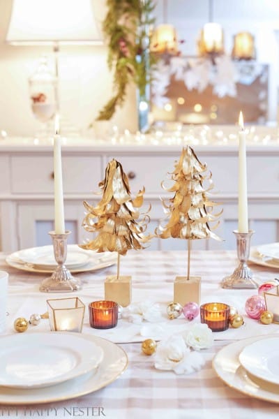 two diy tabletop christmas trees on a decorated holiday table