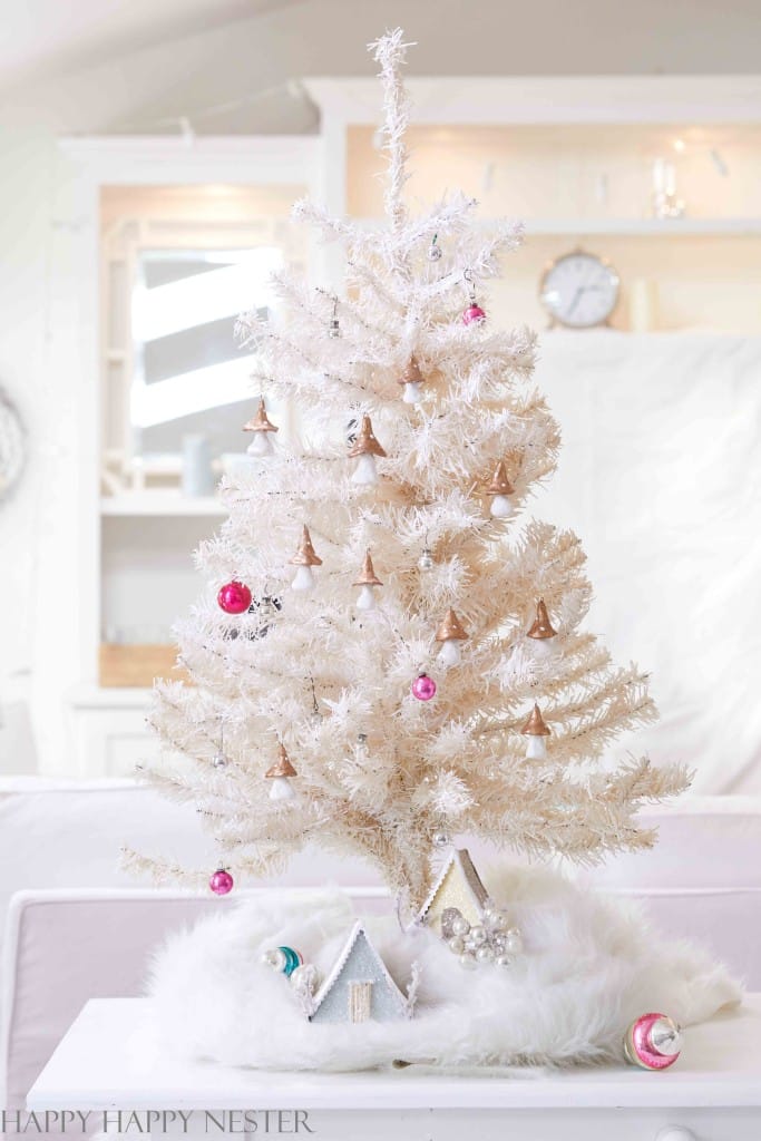 Clay mushrooms hanging on a white table top christmas tree