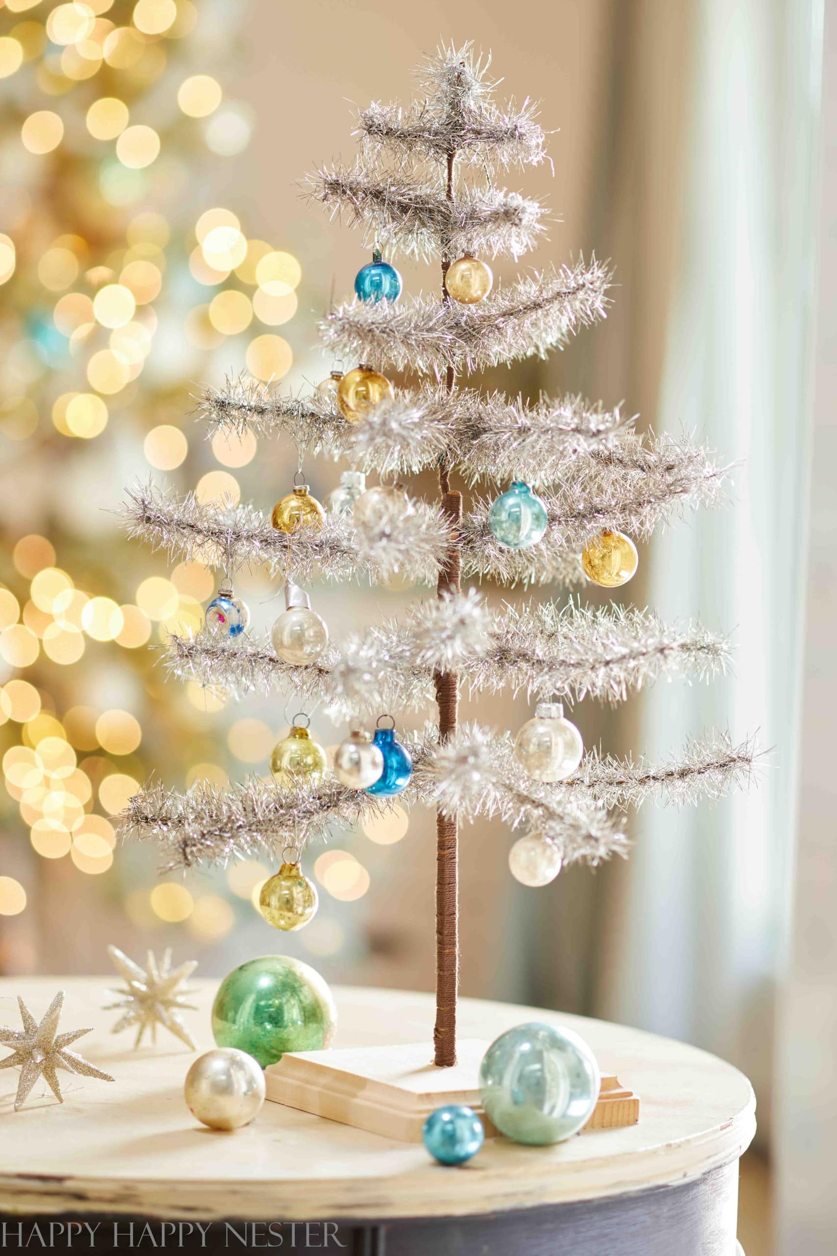 https://happyhappynester.com/wp-content/uploads/2023/11/pretty-tinsel-feather-tree-scaled.jpg