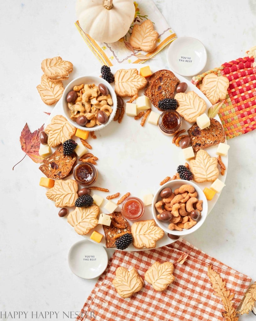 a photo of a complete small charcuterie board in the shape of a wreath on a marble round lazy susan tray