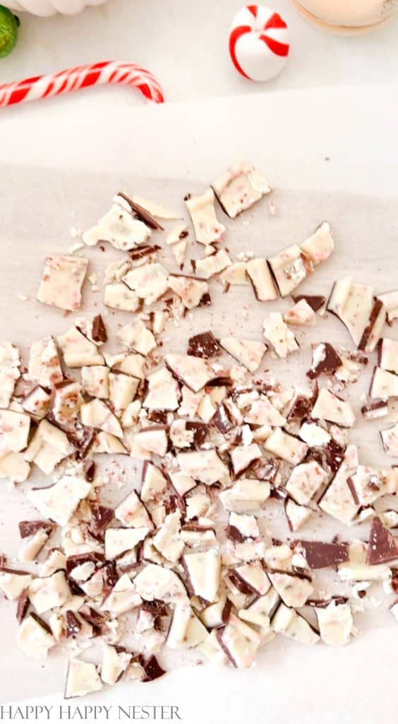 Peppermint chocolate candies chopped up on a wood cutting board