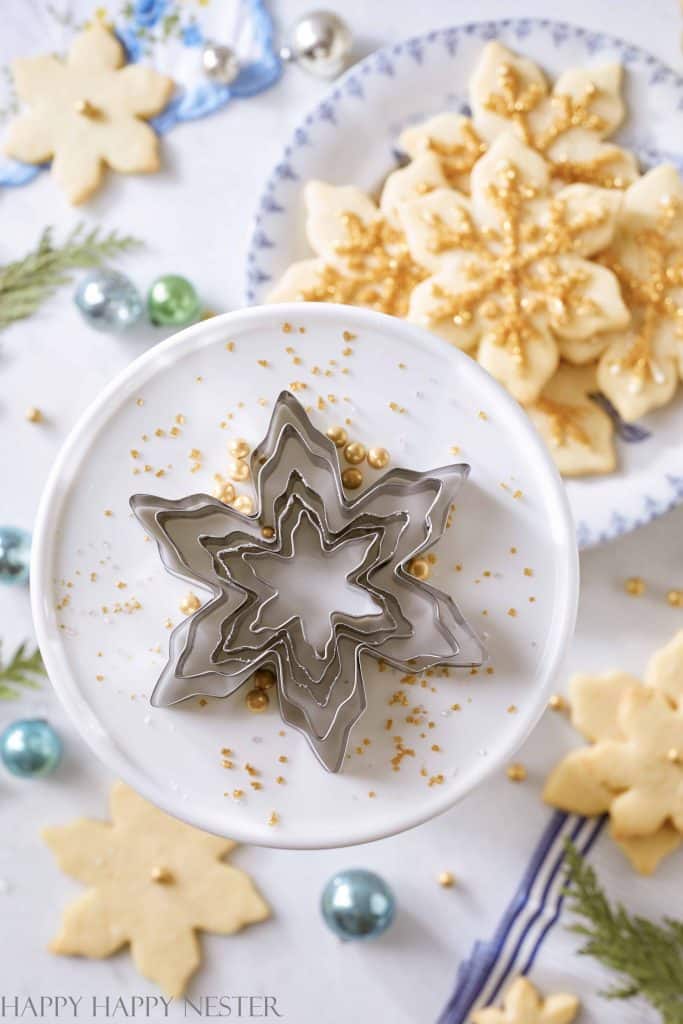 A set of snowflake cookie cutters on a cakestand
