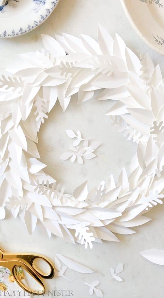 a step by step tutorial showing how to make a paper leaf January winter wreath