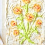 frosted sugar cookie bars with a frosting painting of flowers