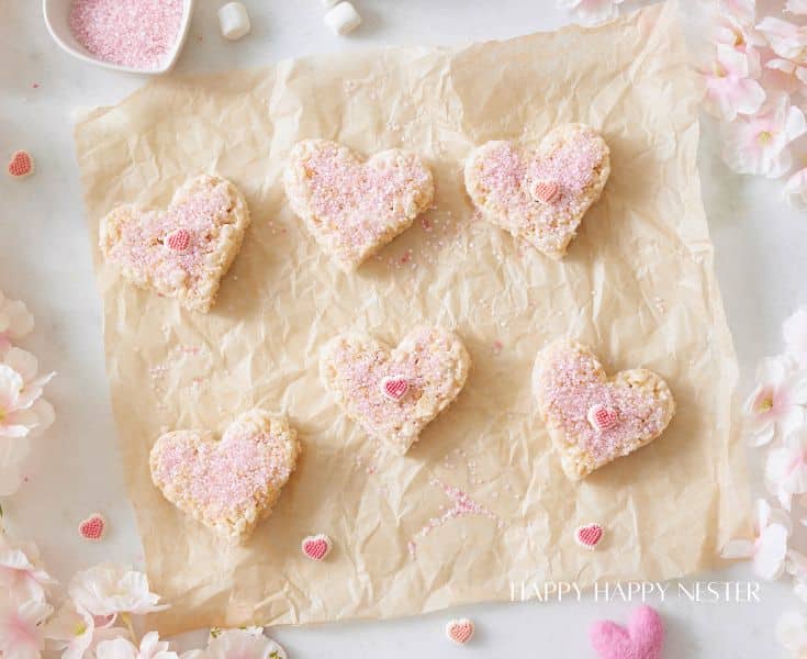 six valentine rice krispie treats on a sheet of brown parchment paper