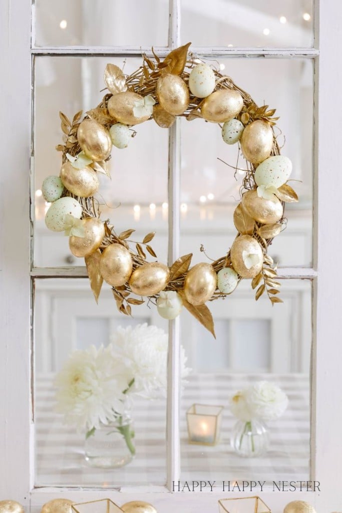 a egg wreath hanging from a window pane