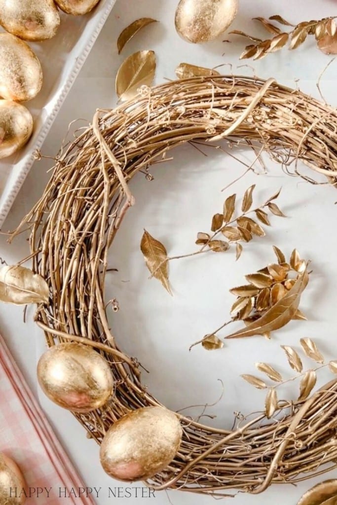 gold leaf faux eggs on a gold grapevine wreath