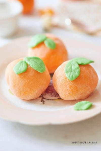 close up three mochis on a plate