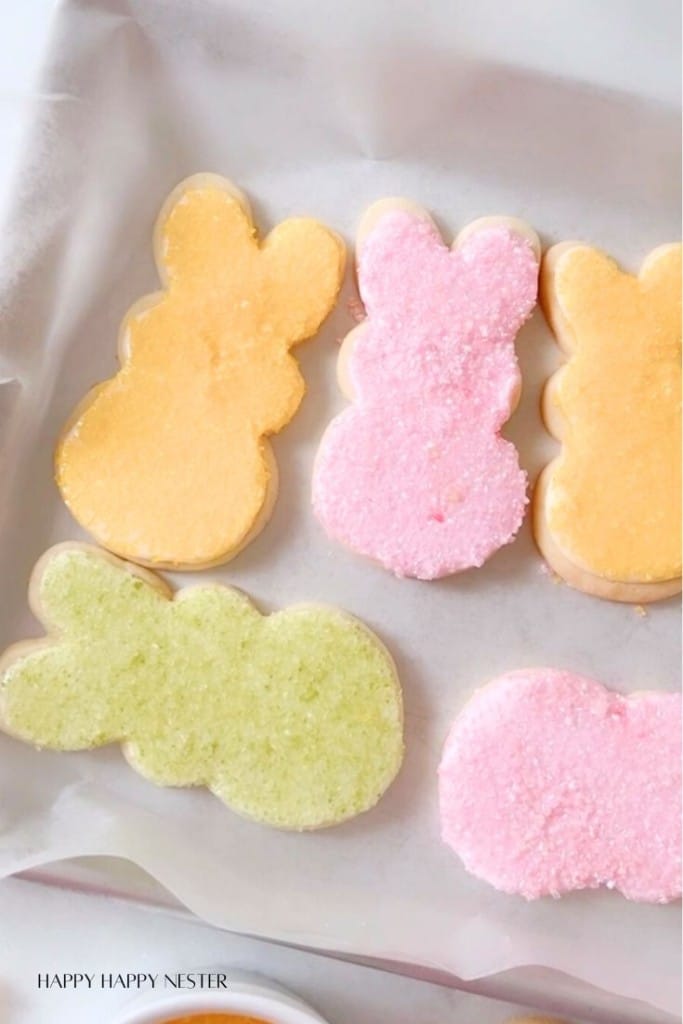 bunny cookies lined up on a baking tray with parchment paper