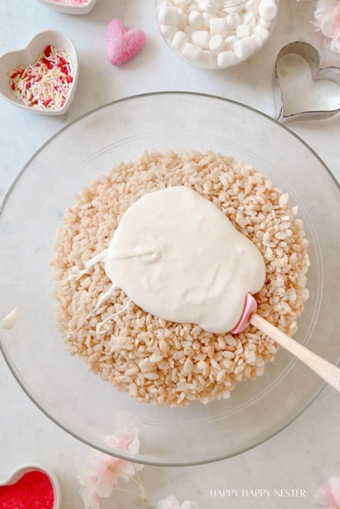 melted marshmallows in the middle of rice krispie cereal in a glass bowl