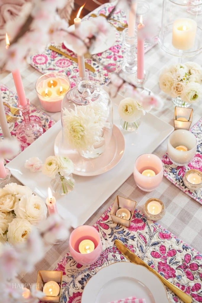 a top down view of the table with all its pink decor and beige gingham table cloth.