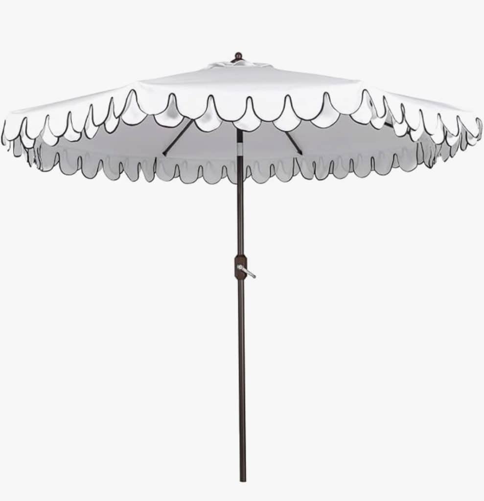 A white patio umbrella with scalloped edges outlined in black, featuring a central pole and a hand crank for easy opening—an amazon find perfect for simple porch decor.