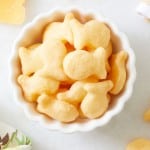 a close up of homemade goldfish crackers in a white little bowl