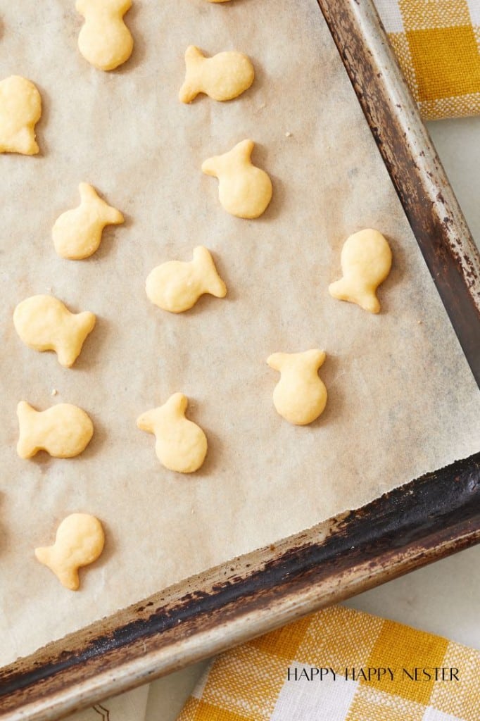 cheese crackers on a baking tray lined with brown parchment paper