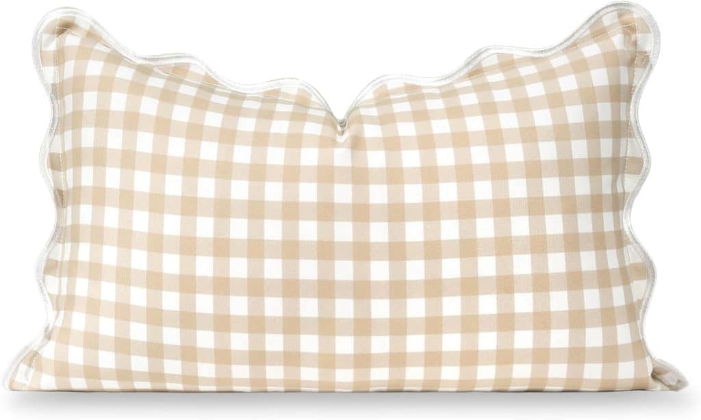 A rectangular pillow with a beige and white gingham check pattern and scalloped edges, perfect as simple porch decor, shown against a white background. Available on Amazon.