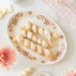 cinnamon breadsticks on a brown plate with cream cheese icing