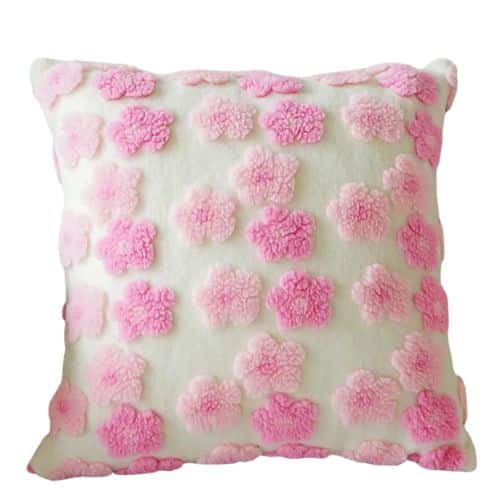 A square white pillow decorated with raised, fluffy pink and light pink flower shapes arranged in a grid pattern, perfect for adding amazon boho throw pillows charm to your space.
