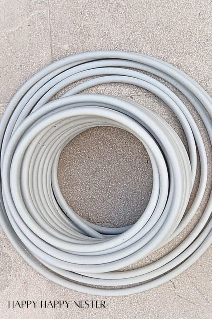 a pile of white irrigation tubing for setting up an irrigation system for plants in pots