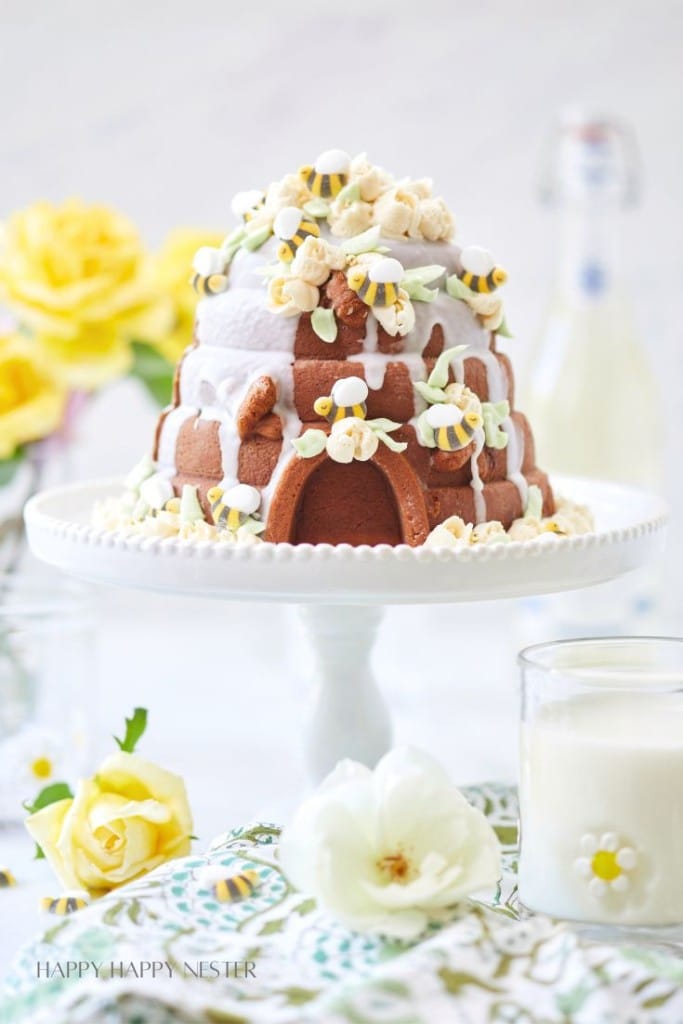 bee hive cake on a white cakestand