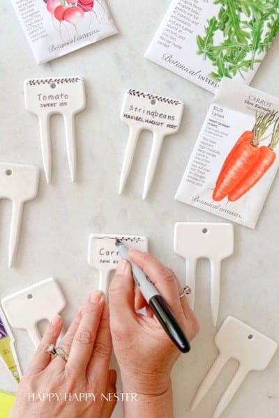 showing how to write on garden markers for your garden