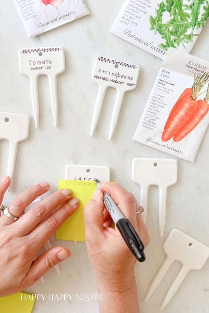Showing how to write on the ceramic planter markers for gardens