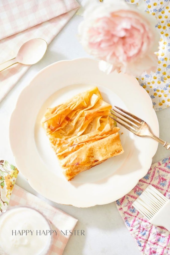 phyllo dough crinkle cake serving sitting on a pink plate with a fork