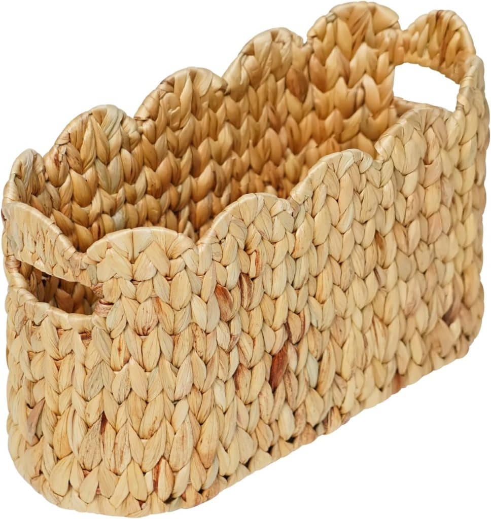 A rectangular woven basket with scalloped edges, made from natural straw or wicker material, featuring two cut-out handles—perfect for adding charm to your rattan decor ideas.