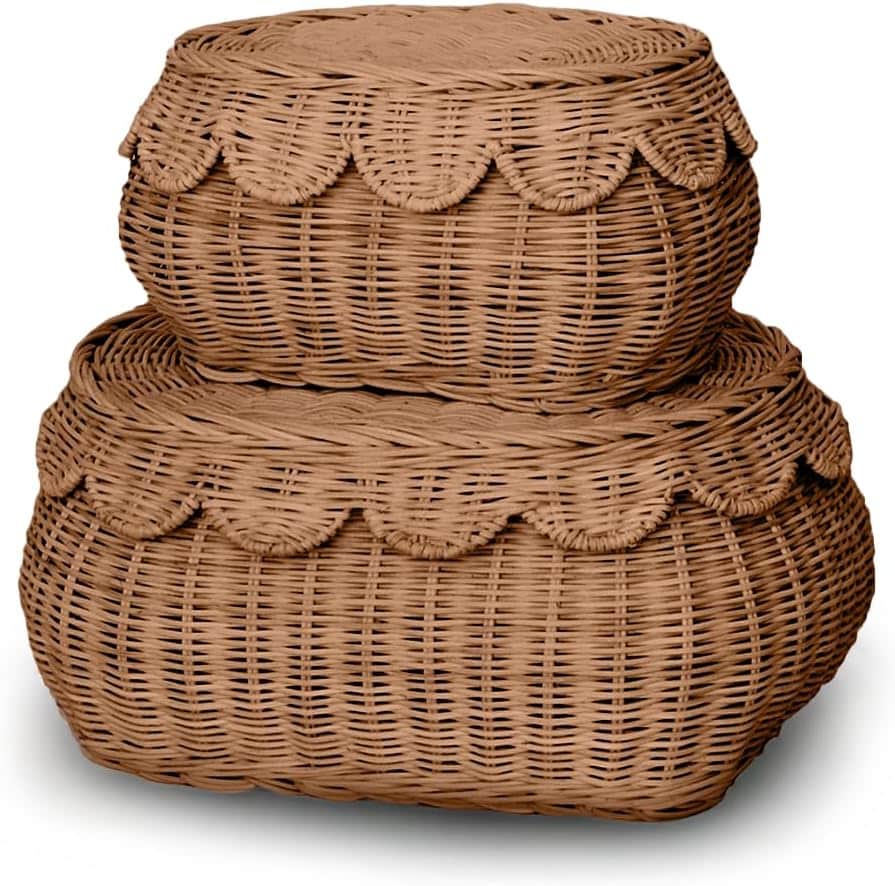 Two round, woven wicker baskets with lids are stacked on top of each other. Both baskets feature a decorative scalloped edge around the lid, making them perfect for adding charming rattan decor ideas to your space.