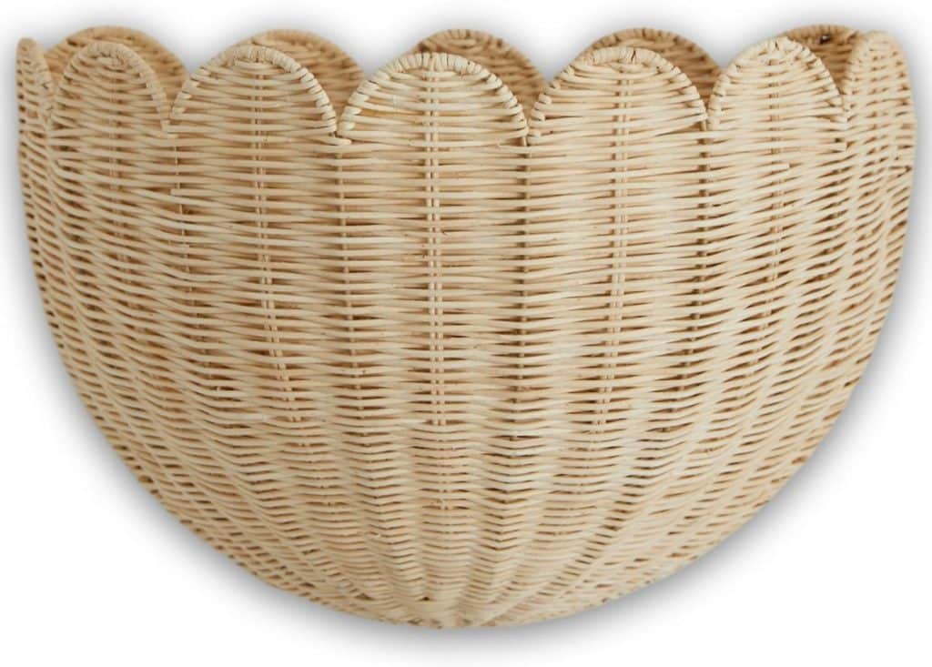 A light-colored, half-round wicker basket with a scalloped edge, perfect for rattan decor ideas. Its woven texture and natural material are clearly visible against the white background.