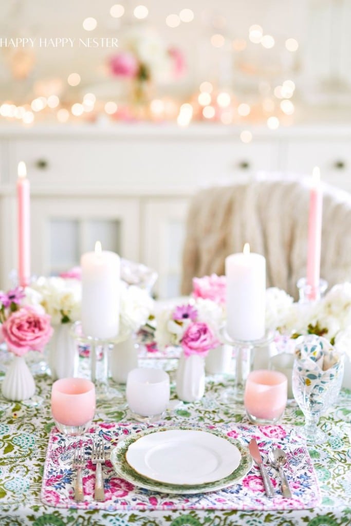 a beautiful table with lots of white vases filled with white roses